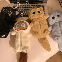 Thumbnail for Four KittyNook Cat Co. Kawaii Big-Eyed Cat Plush Pencil Cases are arranged on a desk in front of a laptop keyboard.