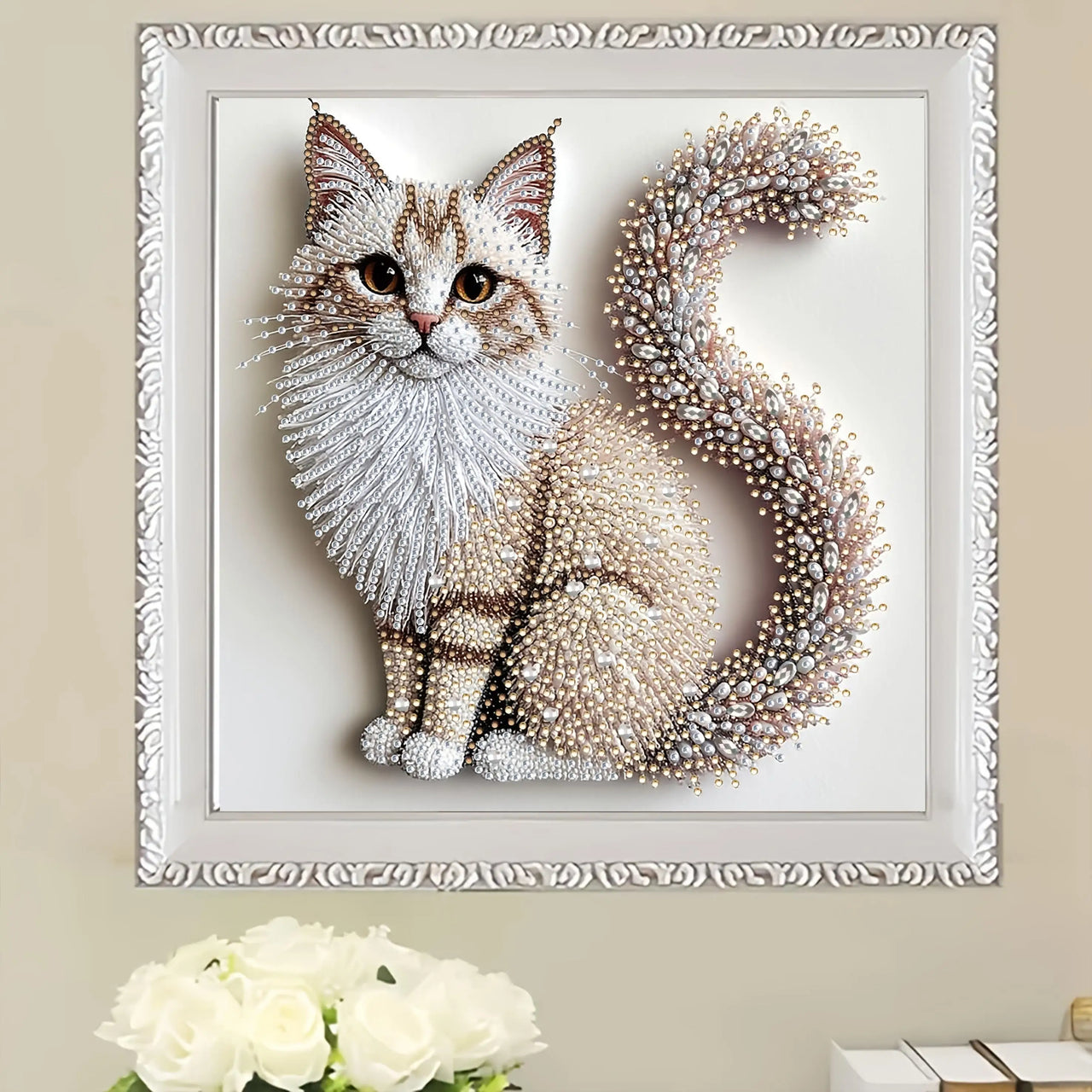 KittyNook Cat Co.'s DIY Crystal Cat Portrait Set with pearl accents shown above white roses on a beige wall.