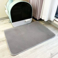 Thumbnail for KittyNook Cat Co. Non-Slip Dual Layer Litter Trapper with honeycomb pattern beside a covered litter box on wood floor.
