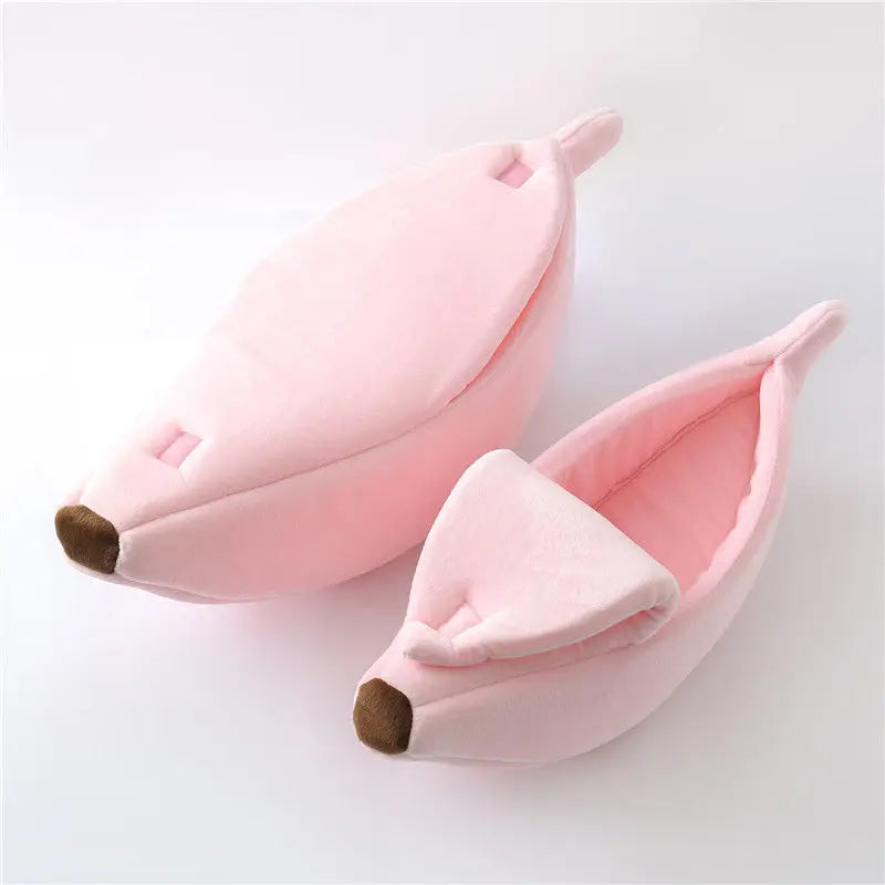 Two pink Cute Funny Banana Shape Cat Beds by KittyNook Cat Co. with brown tips, shown on a white surface.