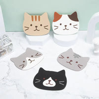 Thumbnail for Five KittyNook Cat Co. Cat Silicone Cup Coaster Mats in assorted colors rest on a white marble surface.