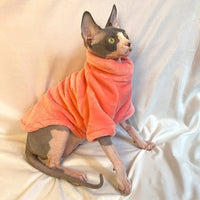 Thumbnail for A Sphynx cat wears a KittyNook Cat Co. Warm Winter Hoodie for Hairless Kittens, sitting on white fabric.