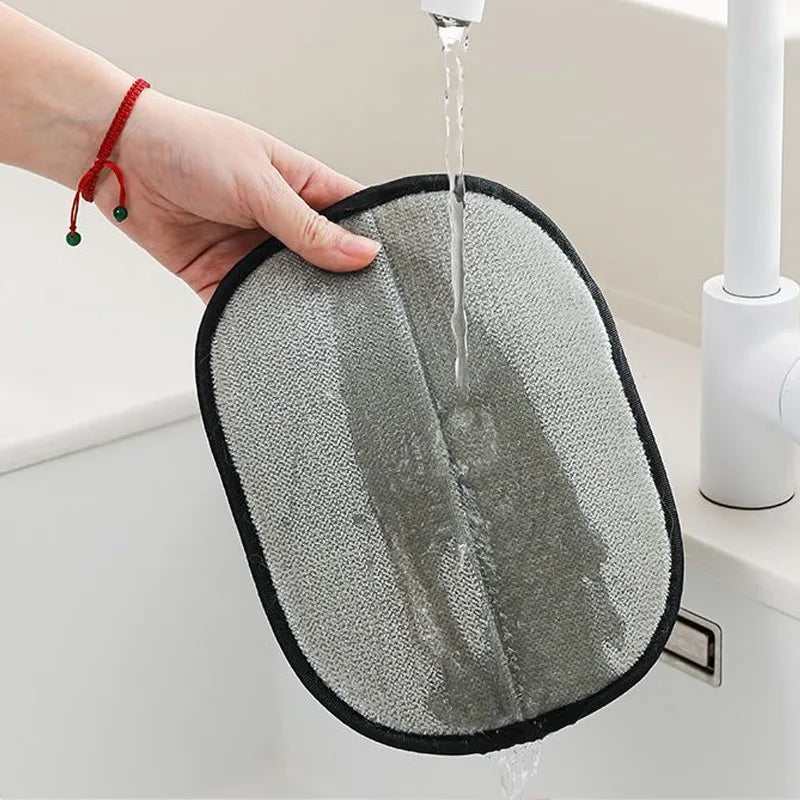 Rinsing KittyNook Cat Co. Pet Hair Removal Mitts under water after cleaning furniture, bedding, or car seats.