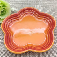 Thumbnail for KittyNook Cat Co. Extra Wide Raised Flower Cat Bowl in orange on a beige woven surface, with a green faux flower nearby.