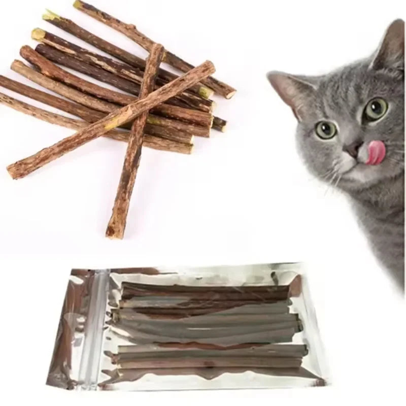 A cat licks its lips by KittyNook Cat Co.’s Natural Silvervine Chew Toy Kit for Cats and similar sticks on white.