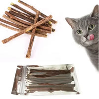 Thumbnail for A cat licks its lips by KittyNook Cat Co.’s Natural Silvervine Chew Toy Kit for Cats and similar sticks on white.