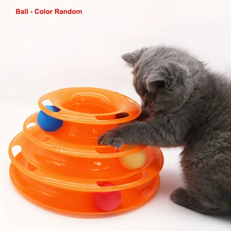 Gray kitten with KittyNook Cat Co. 3-Layer Interactive Cat Toy Tower filled with colorful balls, white background.