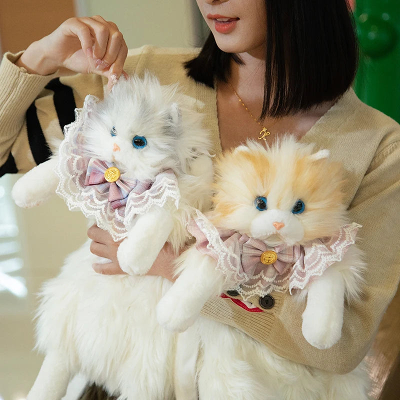 A woman holds two plush cats—ideal companions for The Purrfect Cat Lover’s Bag by KittyNook Cat Co.