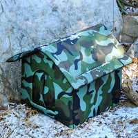Thumbnail for The KittyNook Cat Co. PurrFort Waterproof Outdoor Cat Cave blends into snowy ground with its camouflage design.