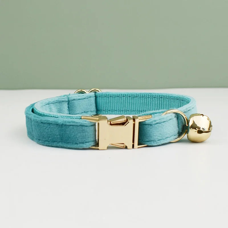 KittyNook Cat Co. Velvet Cat Collar in light blue with gold buckle & bell, shown on a white surface.