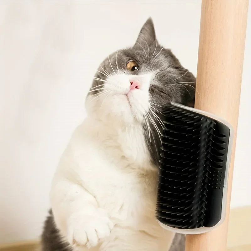 A gray and white cat rubs its face on the KittyNook Cat Co. Ultimate Corner Arch Self-Groomer on a wooden pole.