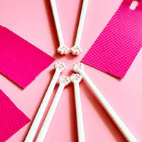 Thumbnail for Six KittyNook Cat Co. Little Paws silicone training chopsticks for kids arranged in a circle on pink, cards nearby.