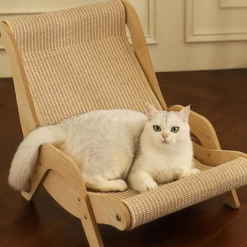 A white cat with green eyes lounges on KittyNook Cat Co.’s Cat Sisal Wooden Chair, a stylish, scratch-resistant piece.
