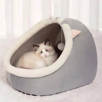 Thumbnail for A white and gray cat lounges in the KittyNook Cat Co. Cute Comfortable Cat Nest Bed with pink ears and a hanging toy.