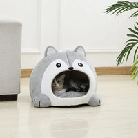 Thumbnail for A gray and white cat lounges in the KittyNook Cat Co. Fluffy Indoor Cat Cave Bed for Kittens on a light wood floor.