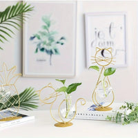 Thumbnail for Two KittyNook Cat Co. Modern Cat Iron Hydroponic Decors with green plants on a white table, books and art behind.