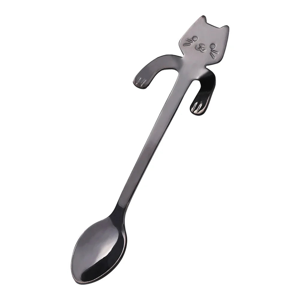 The KittyNook Cat Co. Cat Cling Stainless Steel Mug Spoon has a cat-shaped handle with engraved face and raised arms.