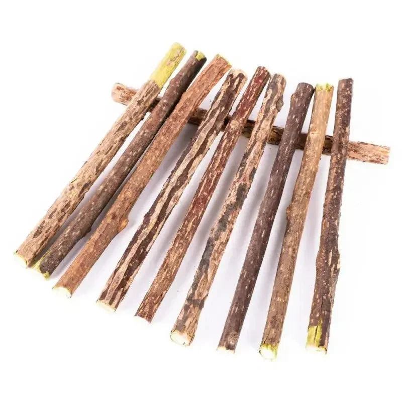 Nine Natural Silvervine Chew Toys by KittyNook Cat Co., lined up with one stick set horizontally on a white surface.