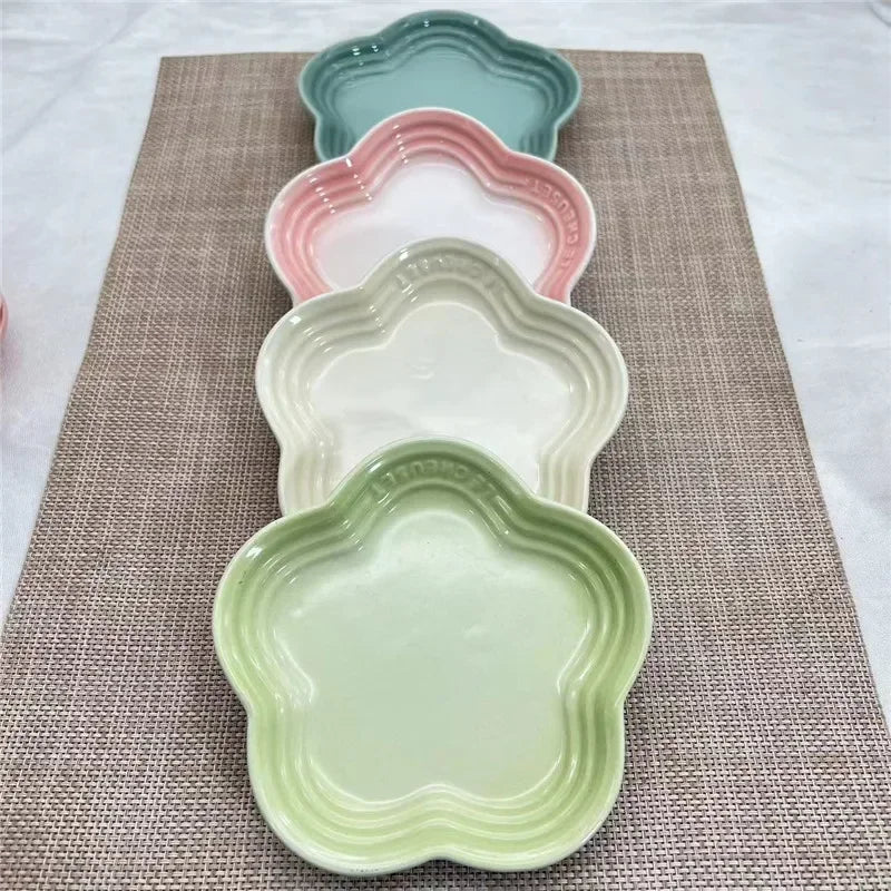 The KittyNook Cat Co. Extra Wide Raised Flower Cat Bowl features a pastel, floral design on a woven brown placemat.