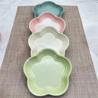 Thumbnail for The KittyNook Cat Co. Extra Wide Raised Flower Cat Bowl features a pastel, floral design on a woven brown placemat.
