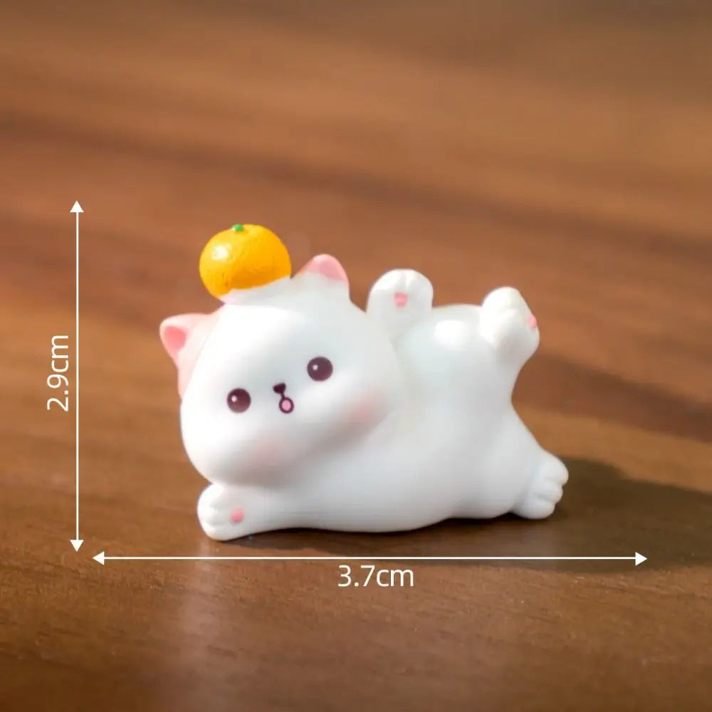 The KittyNook Cat Co. Creative Cat Doll Car Ornament is a 2.9cm x 3.7cm cute resin figurine with an orange on its head.