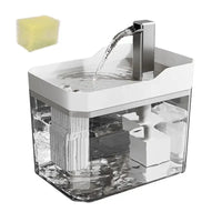 Thumbnail for KittyNook Cat Co. Transparent Cat Water Fountain features an auto filter, running spout, and yellow sponge top left.