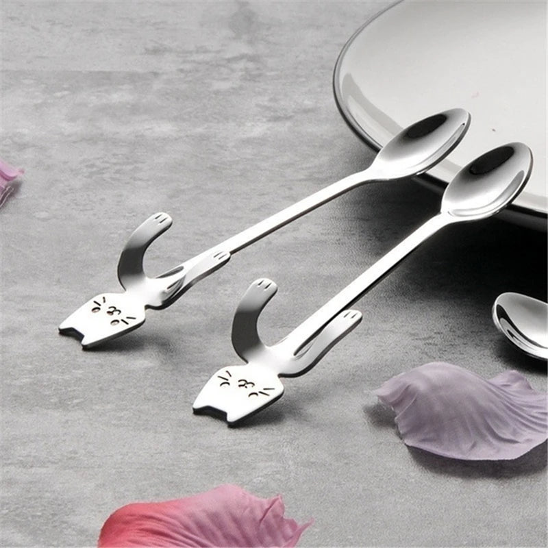 The Cat Cling Stainless Steel Mug Spoon by KittyNook Cat Co. adds a cute cat touch to any mug or coffee break.