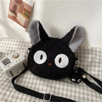 Thumbnail for KittyNook Cat Co. Neko Soft Cat Shoulder Bag—plush black with cat ears, big eyes, keychain, and white camera.