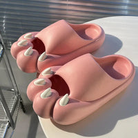 Thumbnail for KittyNook Cat Co. Comfy Outdoor Cat Slippers with kawaii cat faces and white claws, shown on a sunlit round table.