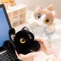 Thumbnail for A person holds a KittyNook Cat Co. Cute Big Eyes Kitten Plush Pillow near a laptop; another sits in a mini cart.