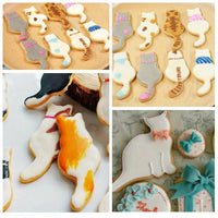 Thumbnail for Cat cookies made with KittyNook Cat Co.'s Cat Shape Cookie Cutter Set, decorated on wooden boards with bows.