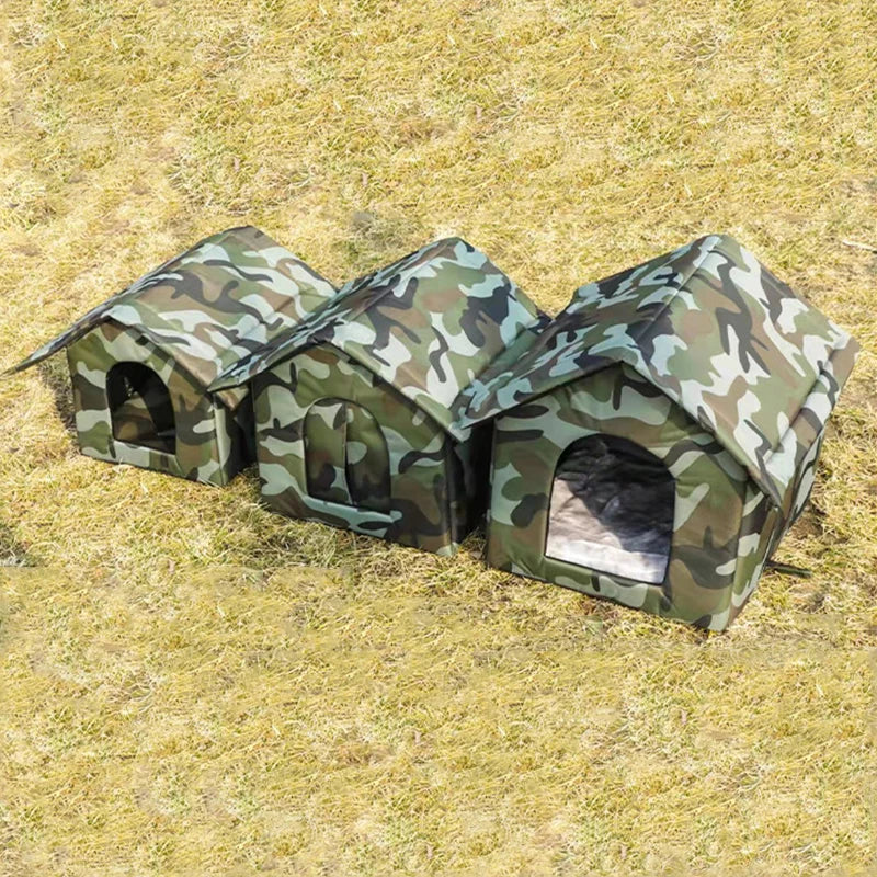 Three PurrFort Waterproof Outdoor Cat Caves by KittyNook Cat Co. in various sizes sit on dry grass outdoors.