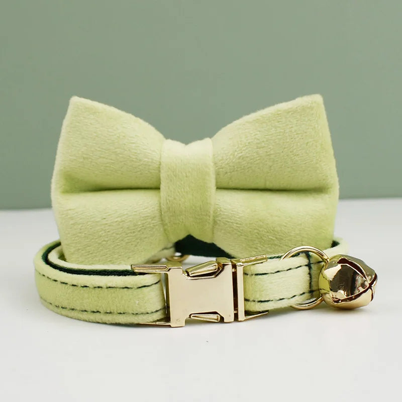 KittyNook Cat Co. Velvet Cat Collar—light green with bow tie & gold bell, purrfect fit on a matching background.
