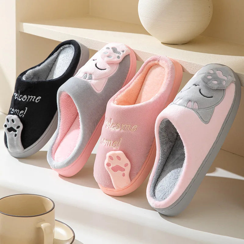 Four pairs of KittyNook Cat Co. Happy Pawprints Lucky Cat Slippers in pastel colors displayed on a shelf.