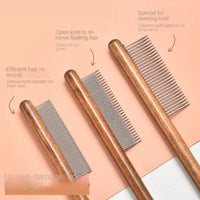 Thumbnail for Three KittyNook Cat Co. Stainless Steel Cat Comb Pros with wooden handles are arranged on a peach surface.
