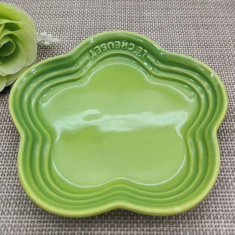 Green Extra Wide Raised Flower Cat Bowl by KittyNook Cat Co. on placemat next to green flower.
