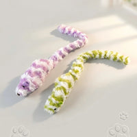 Thumbnail for Two Interactive Mouse Chase Toys by KittyNook Cat Co. make perfect indoor cat toys, lying on a paw print surface.