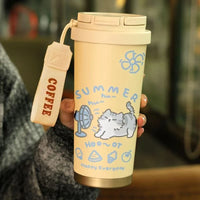 Thumbnail for Hand holding a KittyNook Cat Co. Cartoon Kitty Stainless Steel Travel Cup, light yellow with 