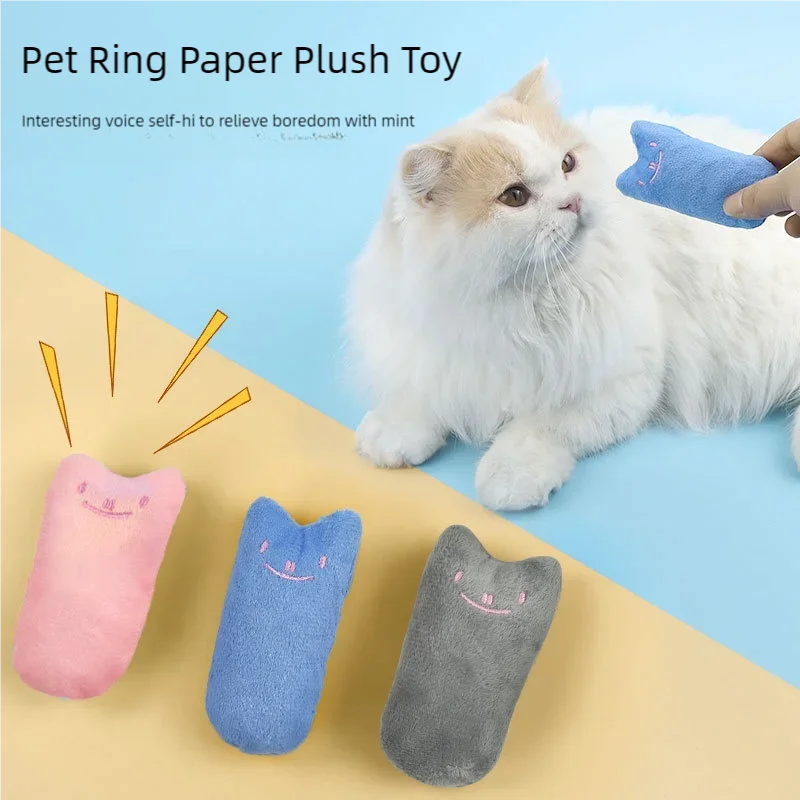 A fluffy white cat eyes KittyNook Cat Co.'s Safe Catnip Chew Toy—pick pink, blue, or gray to ease your cat's boredom.