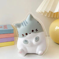 Thumbnail for The KittyNook Cat Co. Cat Squeeze Ball is a cute gray and white squishy cat toy, perfect for stress relief.