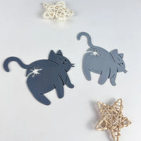 Thumbnail for Two gray KittyNook Cat Co. Cat Butt Bread Clips sit by wicker stars on a white surface.