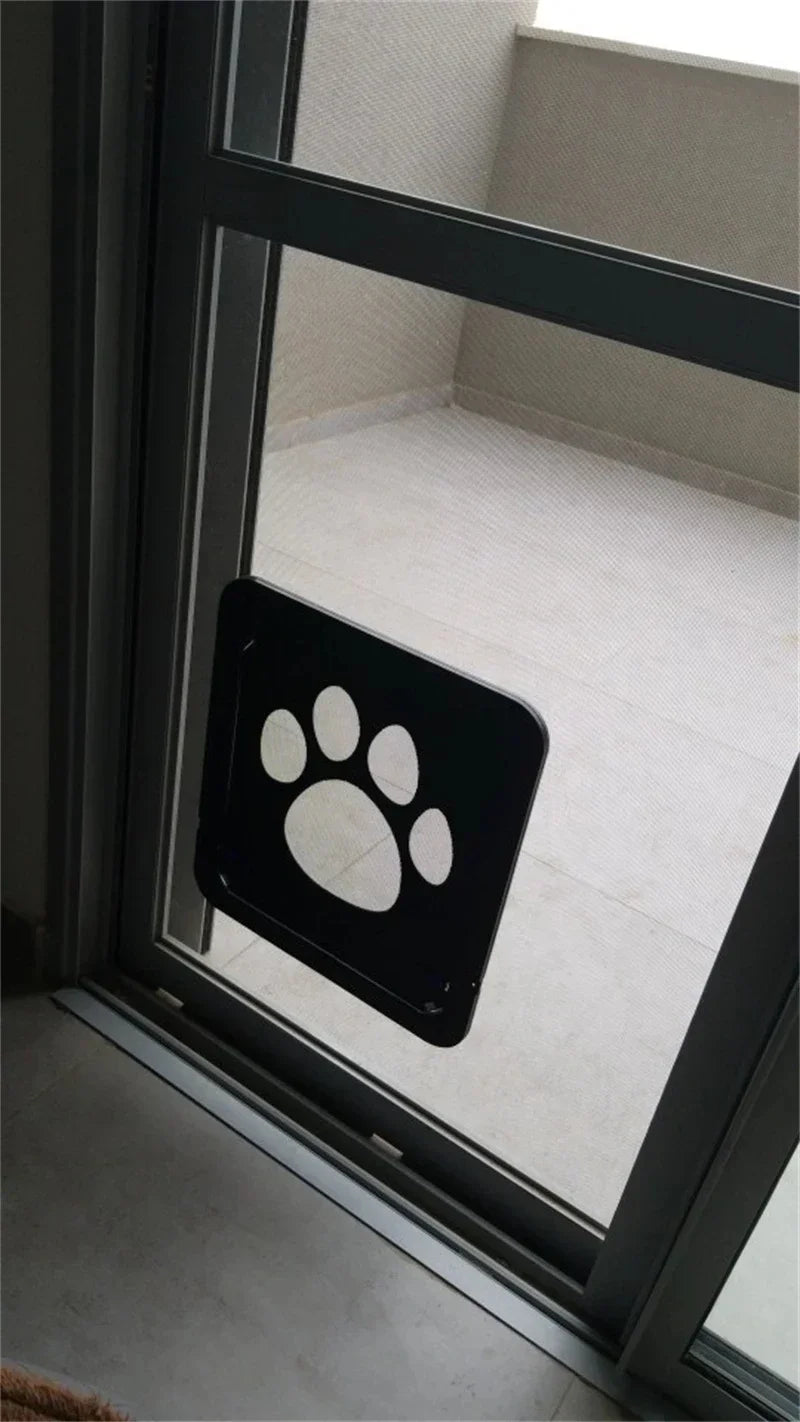 KittyNook Cat Co. Magnetic Lockable Pet Screen Door with paw print opens onto an empty balcony.