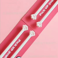 Thumbnail for Four white Little Paws Silicone Training Chopsticks by KittyNook Cat Co. with cat paw tips on a pink background.