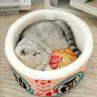 Thumbnail for A gray cat curls up in the KittyNook Cat Co. Giant Ramen Bowl Cat Bed with colorful lucky cat patterns.