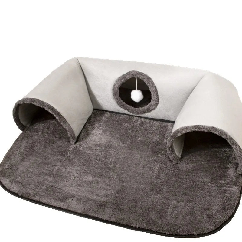 KittyNook Cat Co. Interactive U-shaped Cat Tunnel features two entrances, a hanging ball toy, and a soft mat for cozy play.