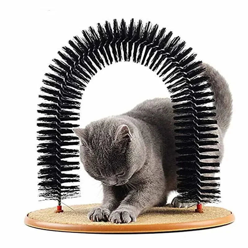 Gray cat uses the KittyNook Cat Co. 3-in-1 Cat Self-Grooming Arch Toy with pad for stretching and fur removal.