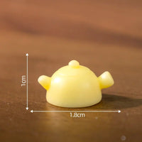 Thumbnail for A 1cm yellow teapot sits beside the KittyNook Cat Co. Creative Cat Doll Car Ornament on a wooden surface.