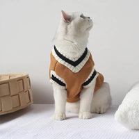 Thumbnail for A white cat in a KittyNook Cat Co. Cozy Fluff Cat Sweater sits by a basket, looking up against a plain background.