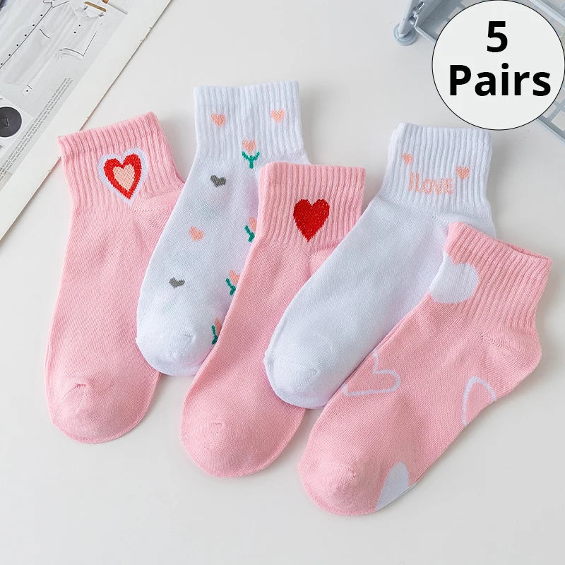 Five pairs of KittyNook Cat Co. Sweet Kitty Pink Short Tube Socks with heart designs displayed on a white surface.