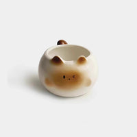 Thumbnail for KittyNook Cat Co. Siamese Cat Coffee Cup with a round shape, tail handle, and winking face—perfect for cat lovers.